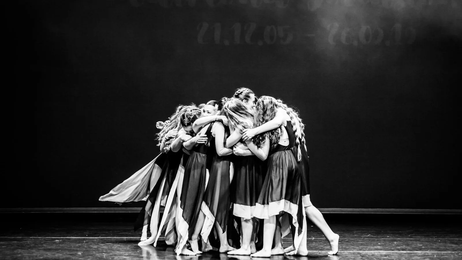 TDC dancers huddled on stage